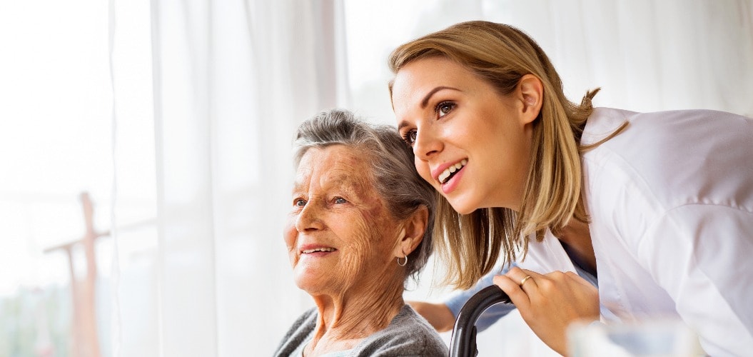 Health visitor and a senior woman during home visit.