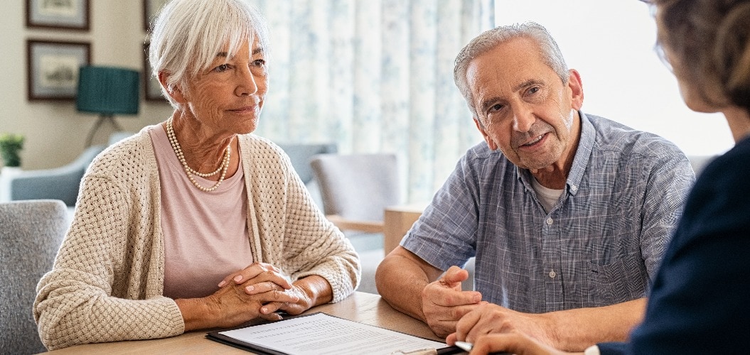 Senior couple planning their investments with financial advisor